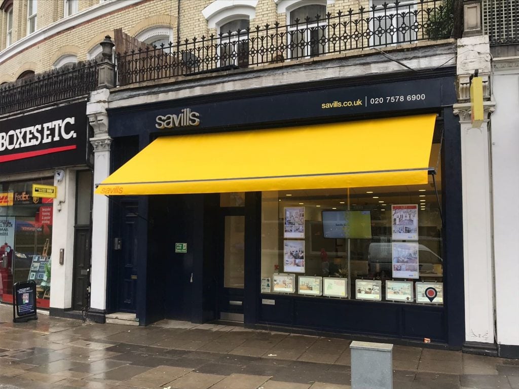 Savill's estate agents branch 0ffice bright yellow shop awning