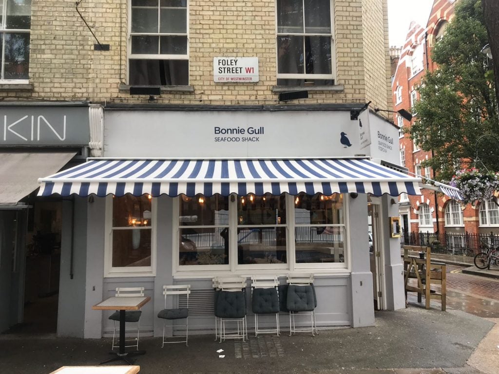 Blue and white stripe fabric restaurant awning