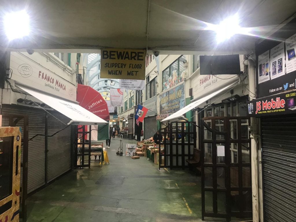 Brixton Market shop alley aligned with awnings