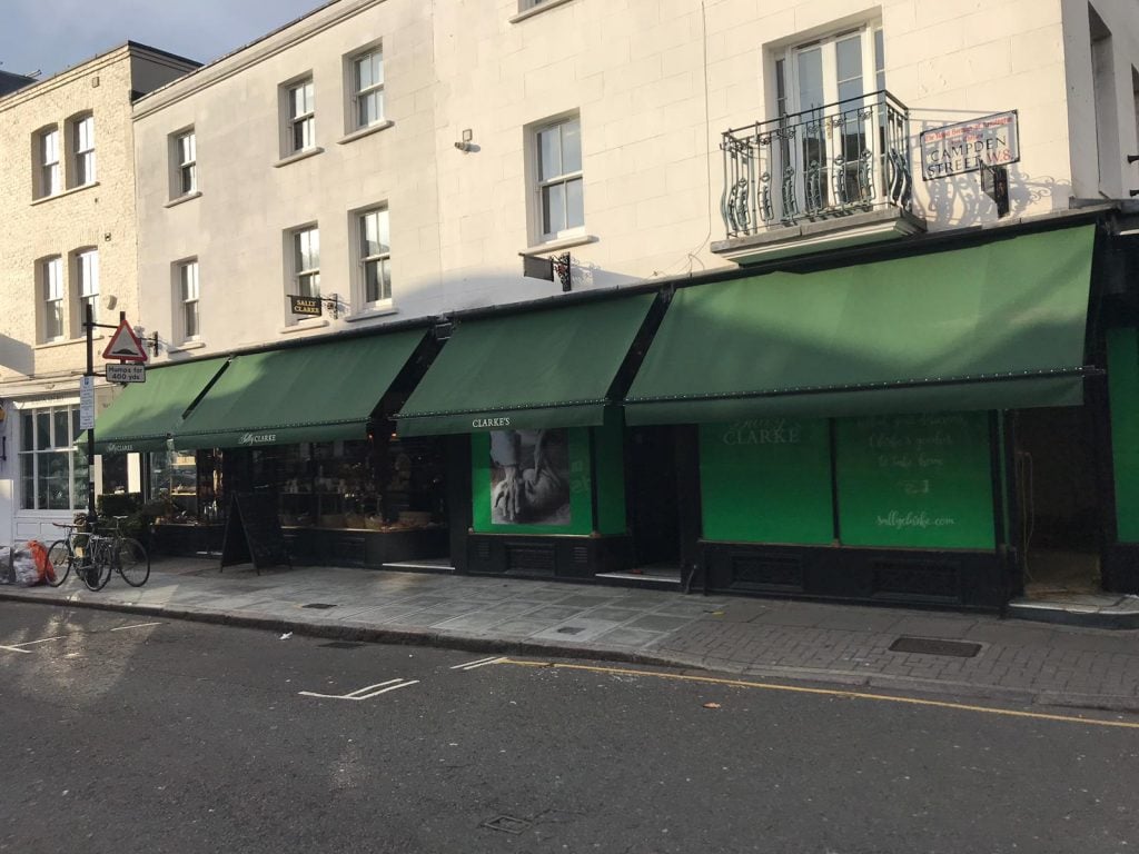 4 green shop awnings in a row