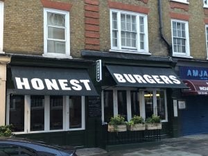 Black restaurant awning with white bold signage