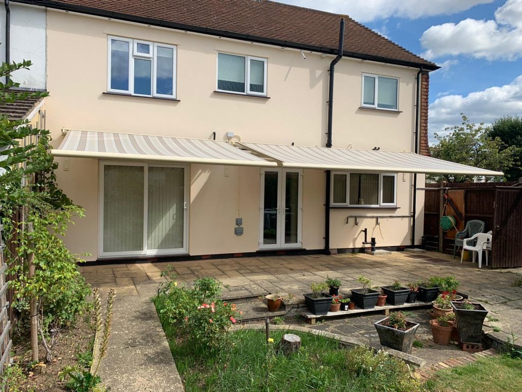 Cream-colored patio awning with grey stripes