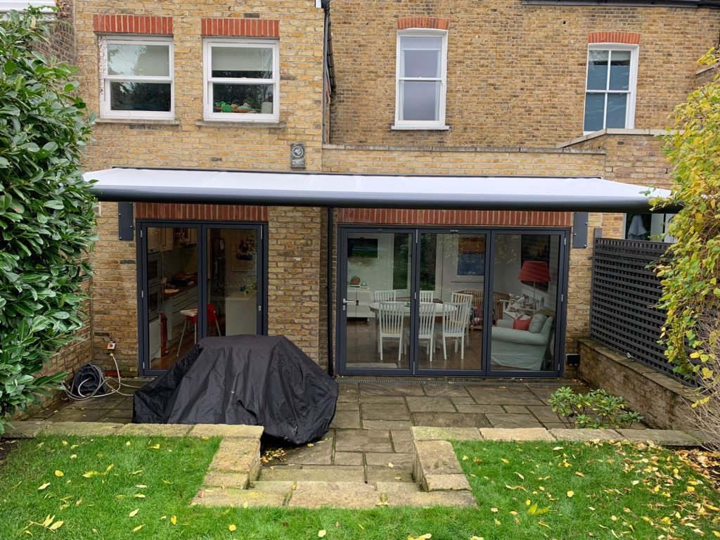 Wide grey patio awning of house