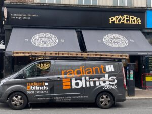 Radiant blinds work van parked in front of refurbished awning