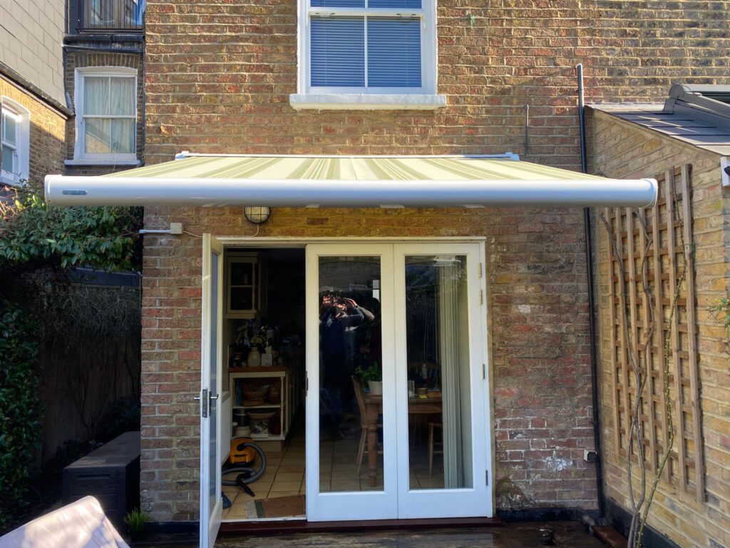 Yellow and white striped patio awning front view