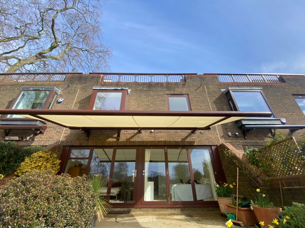 Light yellow wide patio awning underside view