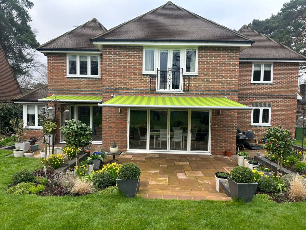 Light green striped patio awning of house front view