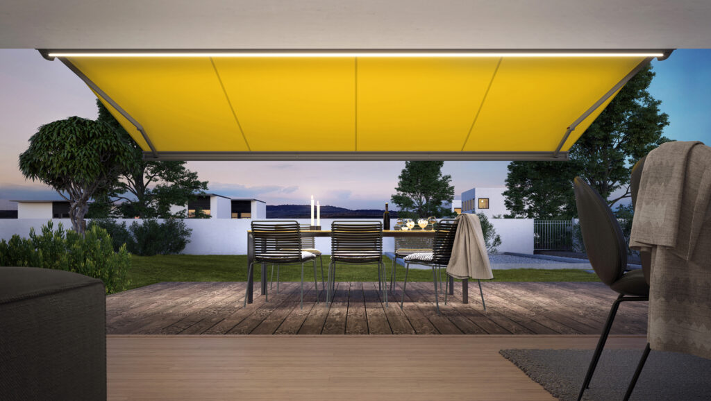 Backyard view of wide yellow patio awning