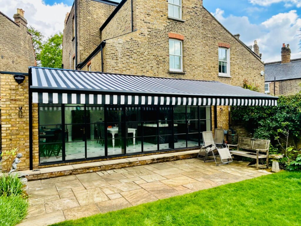 White and black striped patio awning near side view