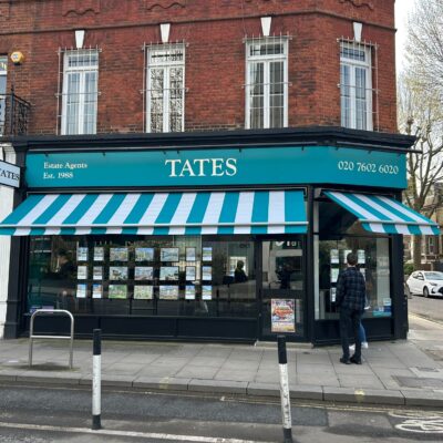 Blue-green striped shop awning as seen across street