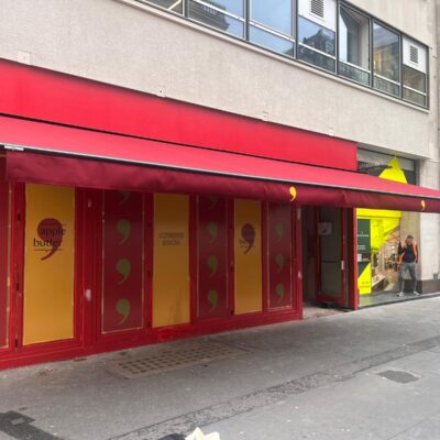 Red wide restaurant awning on near sde view